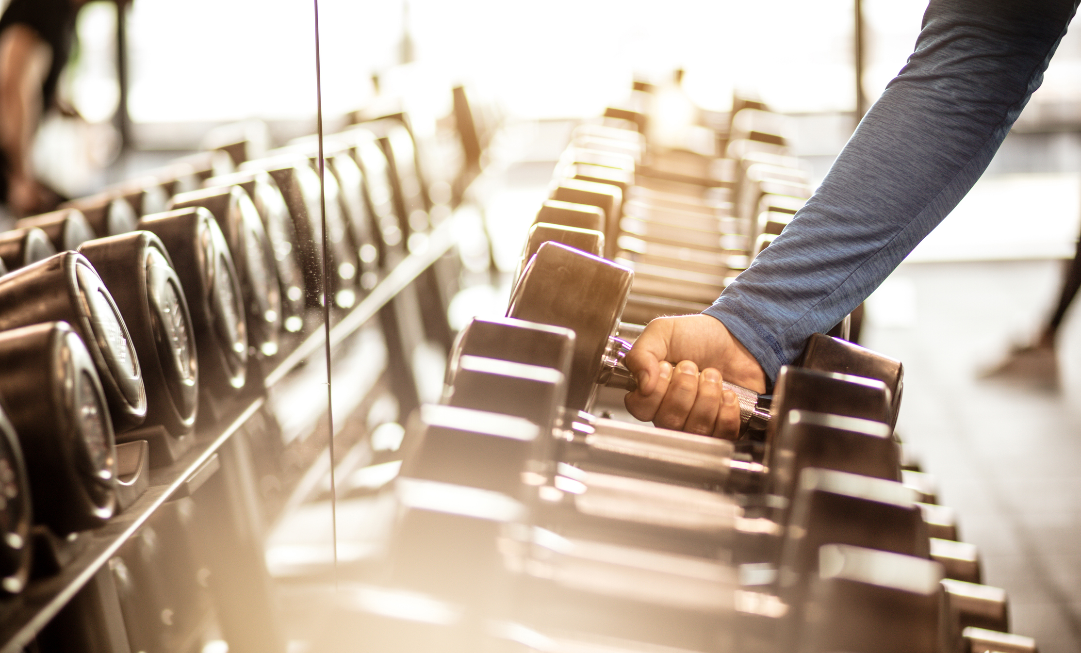 woman picking dumbbells
