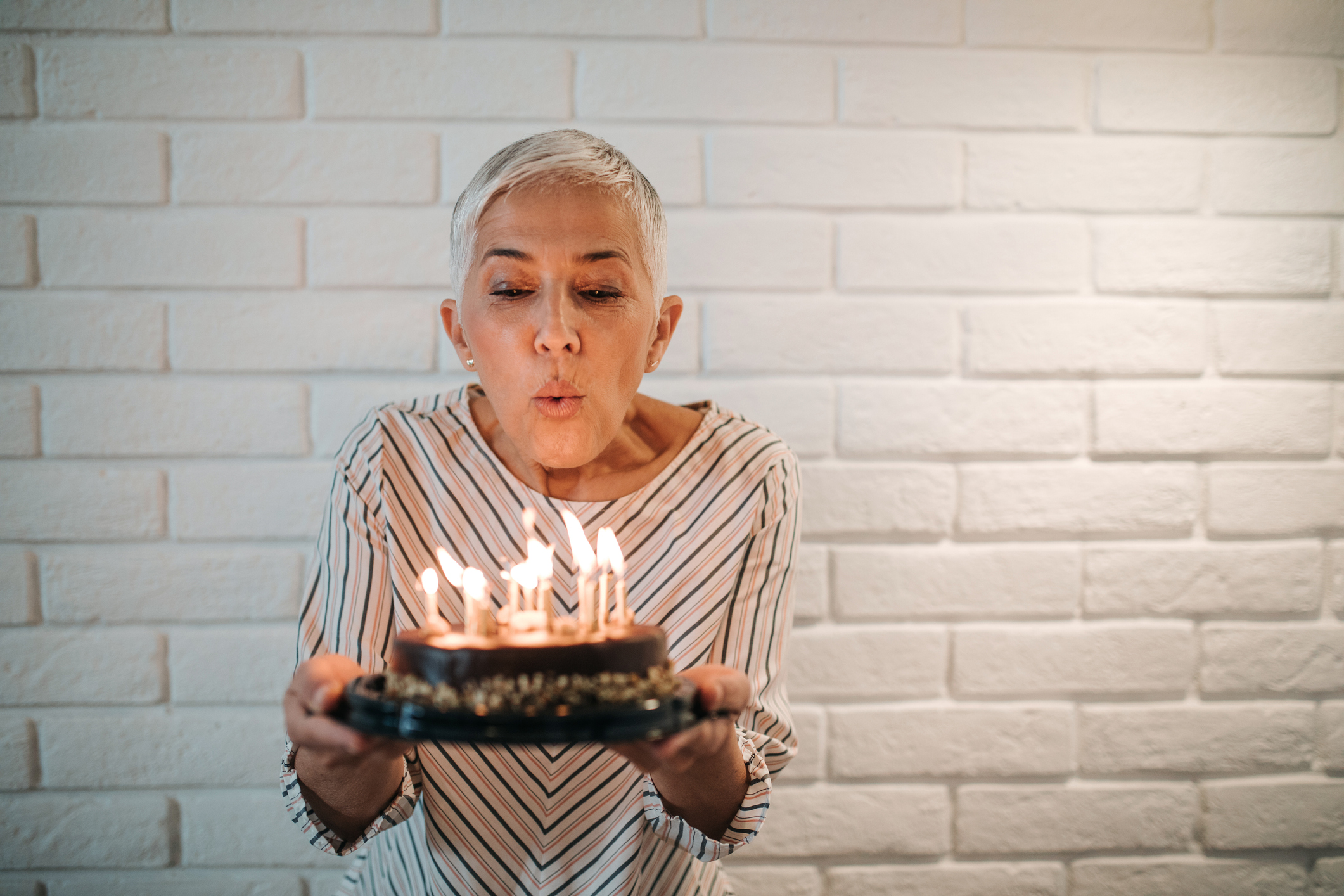 woman blowing out candles