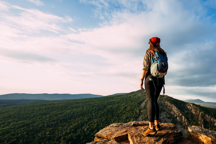 woman hiker standing on a cliff